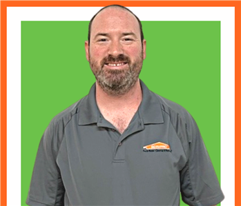 Andrew, SERVPRO employee, cut out and set against a green backdrop