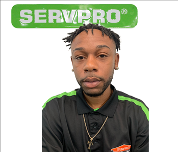 Taurus, SERVPRO employee, in front of white background and green servpro sign