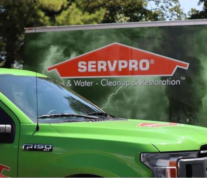 Call us today! - Image of green SERVPRO vehicles.
