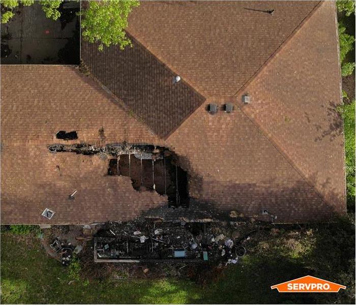 aerial view of the roof of a damaged house, red roof